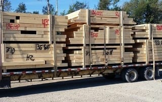 A trailer stacked with prefabricated walls ready for use