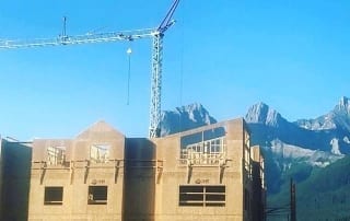 A crane looms over a building under construction