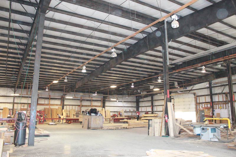 A large warehouse garage with miscellaneous construction material
